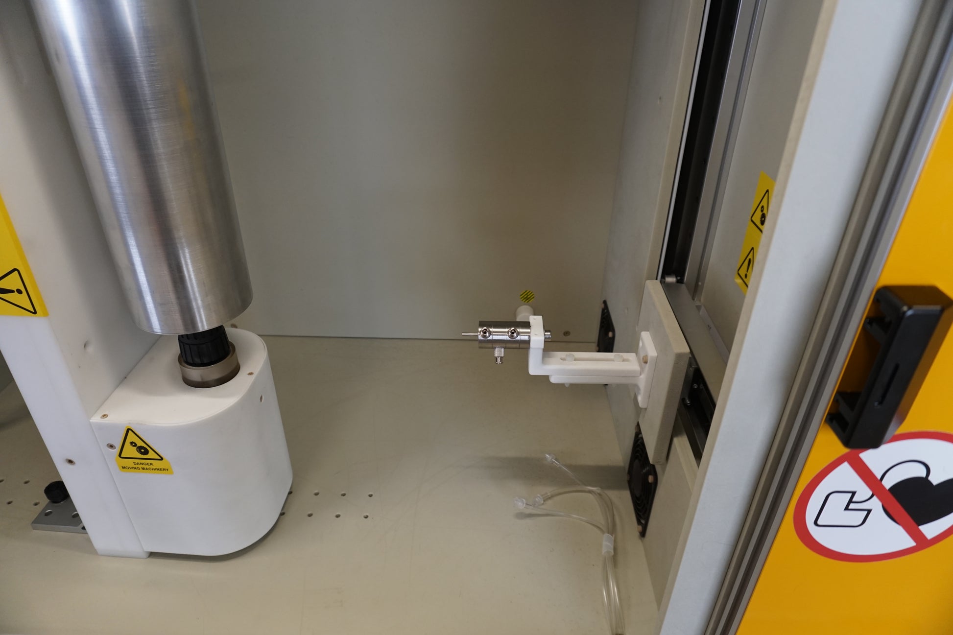 Picture of internal detail of Compact electrospinning unit by Linari Nanotech.
drum collector on the left side in vertical position with motor on the lower part. coaxial needle as emitter on the right side installed on X-Y gantry to move along the collector axes and to align with .