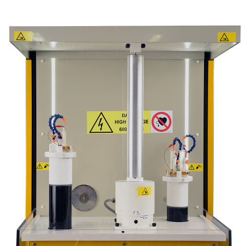 Picture of electrospinning chamber of  RT Advanced electrospinning system by Linari NanoTech. Vertical drum collector in the center and on both sides the two pump assemblies with high voltage generators 60 kV and 4 pumps each one.